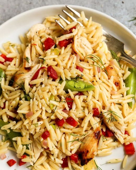 grilled chicken and lemon orzo pasta salad on white plate