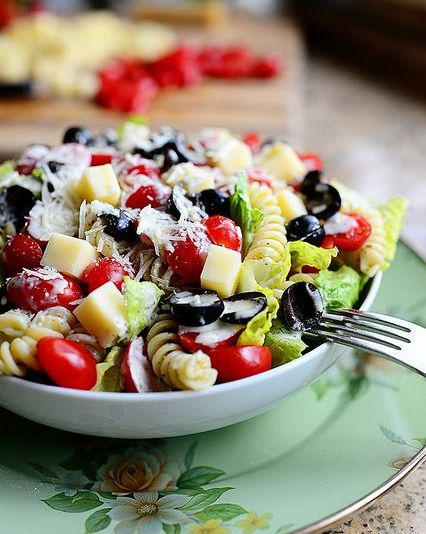 pesto pasta salad with black olives in bowl