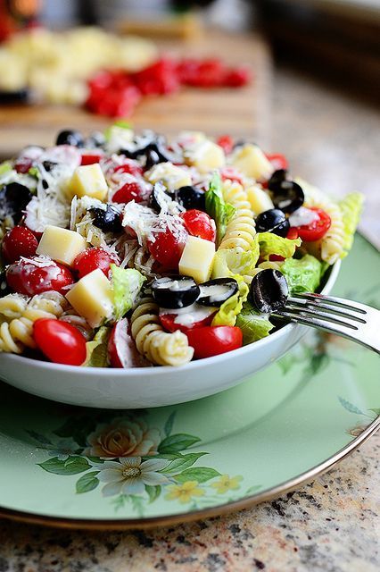 pesto pasta salad with black olives in bowl