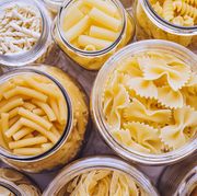 variety of types and shapes of italian pasta in glass jars