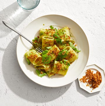 pasta dish with pesto sauce and toasted breadcrumbs on top