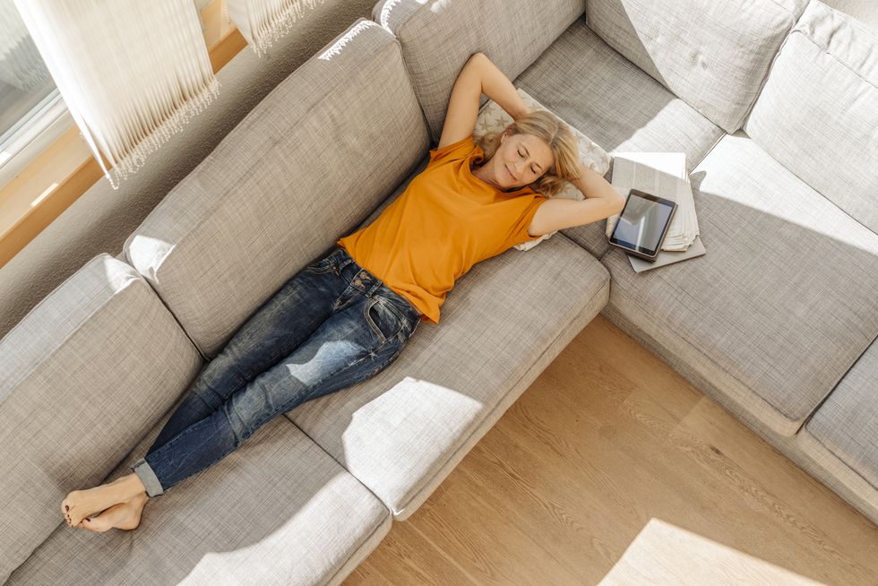 Woman at home lying on couch