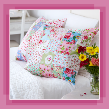 patchwork crochet cushions on white bed