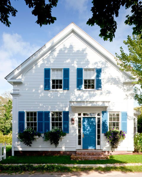 white colonial house with bright blue door and shutters