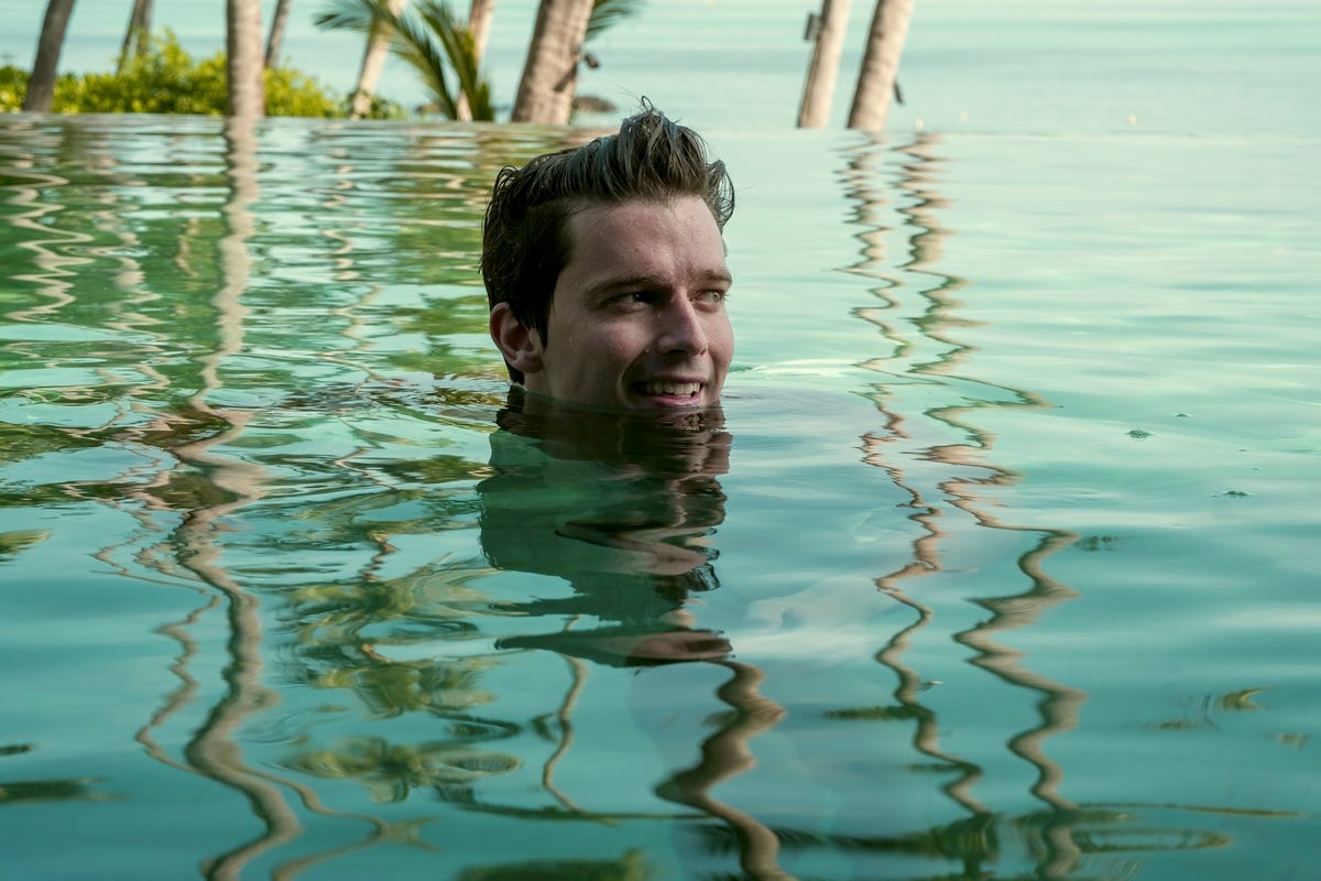 Person partially submerged in a tranquil swimming pool