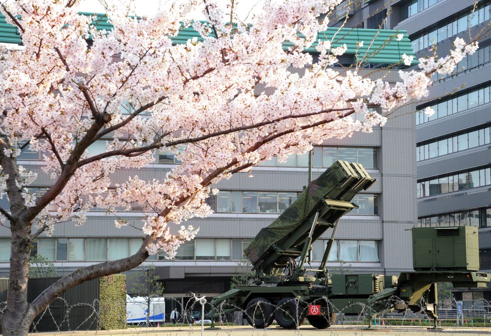a patriot advanced capability 3 pac 3 in japan with a cherry tree blossoming to the left
