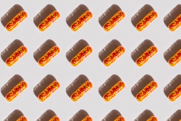 pattern made of red orange capsule with medicine with iron, vitamin b, vitamin c, folic acid, zinc on a white background with shadow