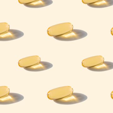 a pattern of omega capsules on a beige background
