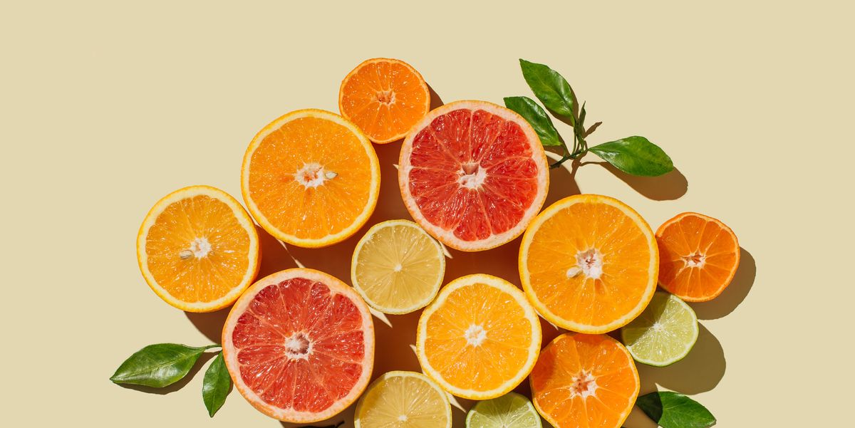 pattern of slices citrus fruit of lemons, oranges, grapefruit, lime on beige background healthy food, diet and detox concept flat lay, top view