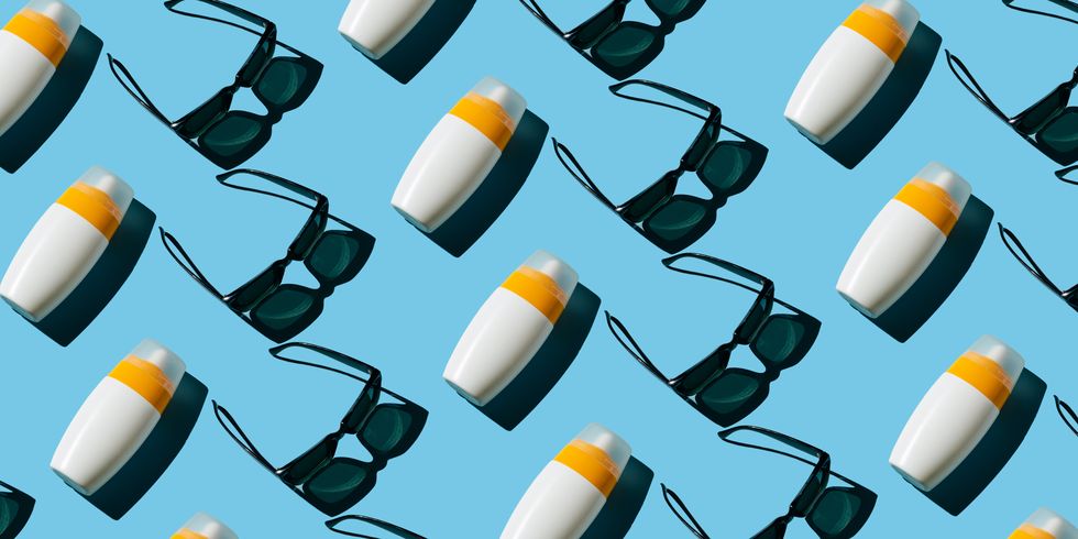 pattern of sunscreen and sunglasses on blue background summer holidays concept