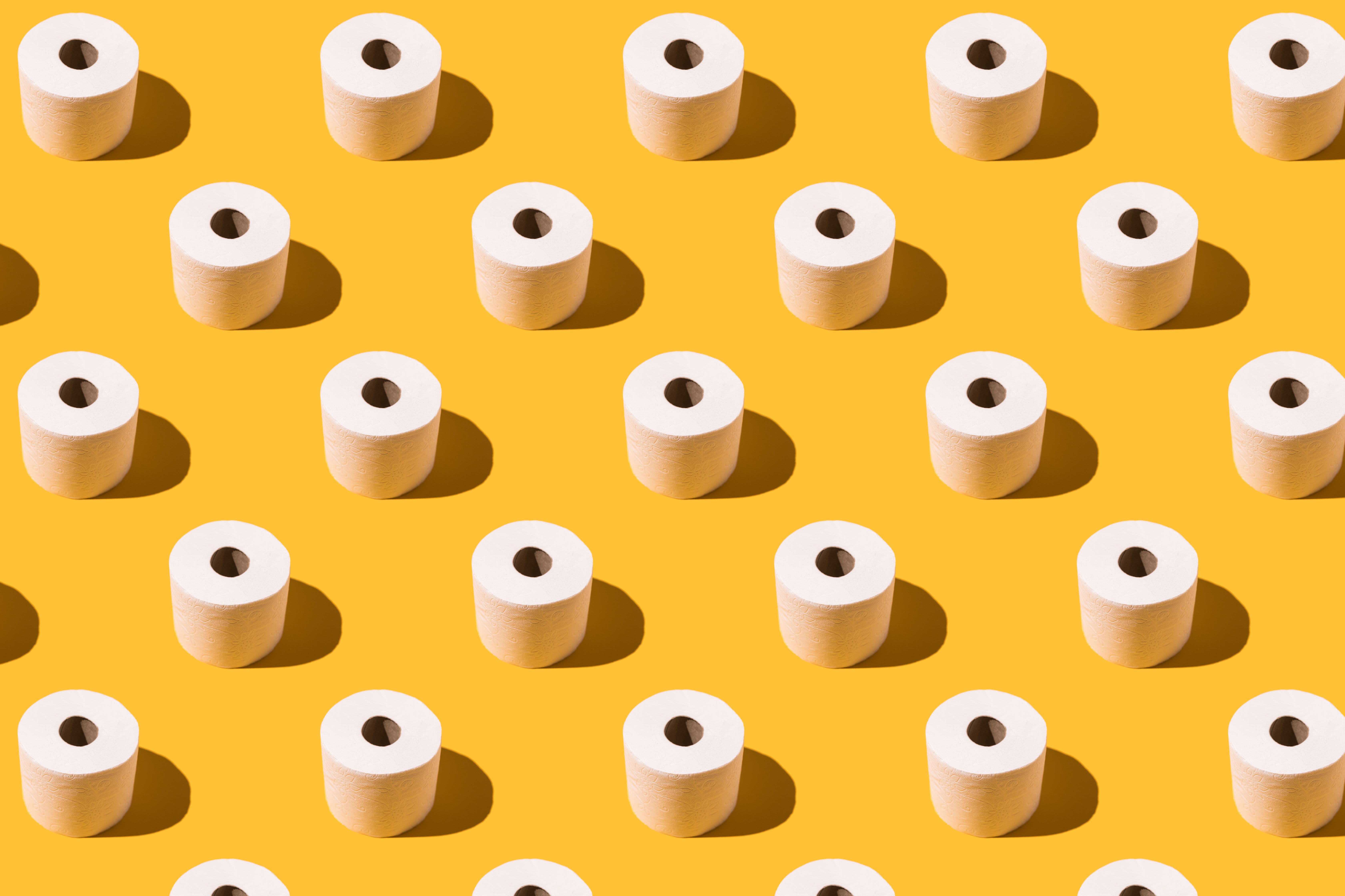 https://hips.hearstapps.com/hmg-prod/images/pattern-of-white-toilet-paper-rolls-on-yellow-royalty-free-image-1681241705.jpg