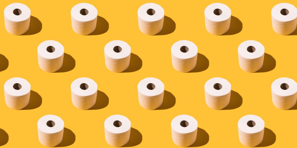 pattern of white toilet paper rolls on yellow background concept of going to the bathroom, cleaning and pooping and peeing