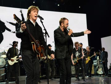 paul mccartney playing a guitar and ringo starr singing