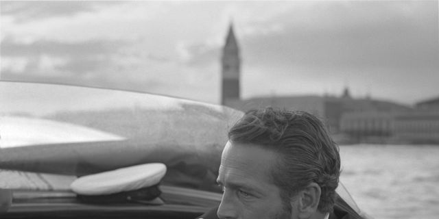 american actor paul newman, wearing a tuxedo and a bow tie, portrayed during a trip on a water taxi, a sailor cap on the dashboard, st mark square in the background, venice 1963 photo by archivio cameraphoto epochegetty images