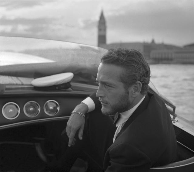 american actor paul newman, wearing a tuxedo and a bow tie, portrayed during a trip on a water taxi, a sailor cap on the dashboard, st mark square in the background, venice 1963 photo by archivio cameraphoto epochegetty images