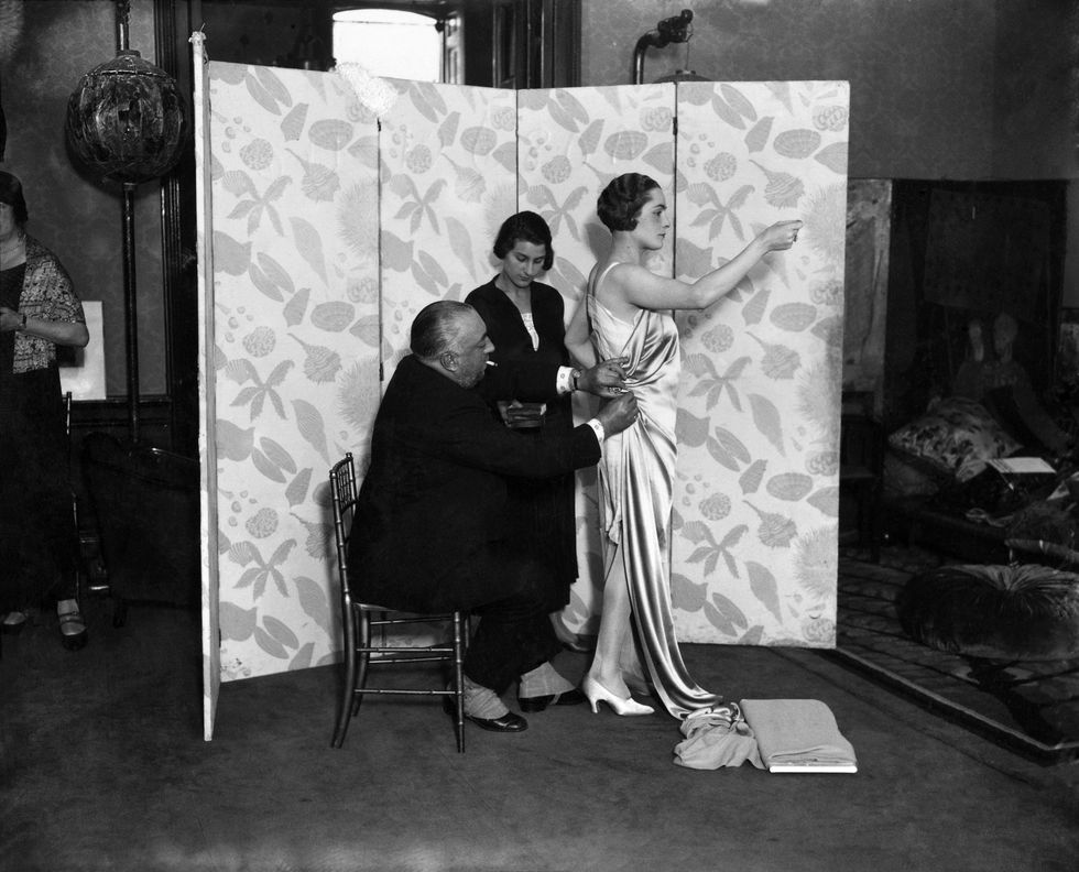 m paul poiret designing a gown on one of his mannequins december 1924 p008637