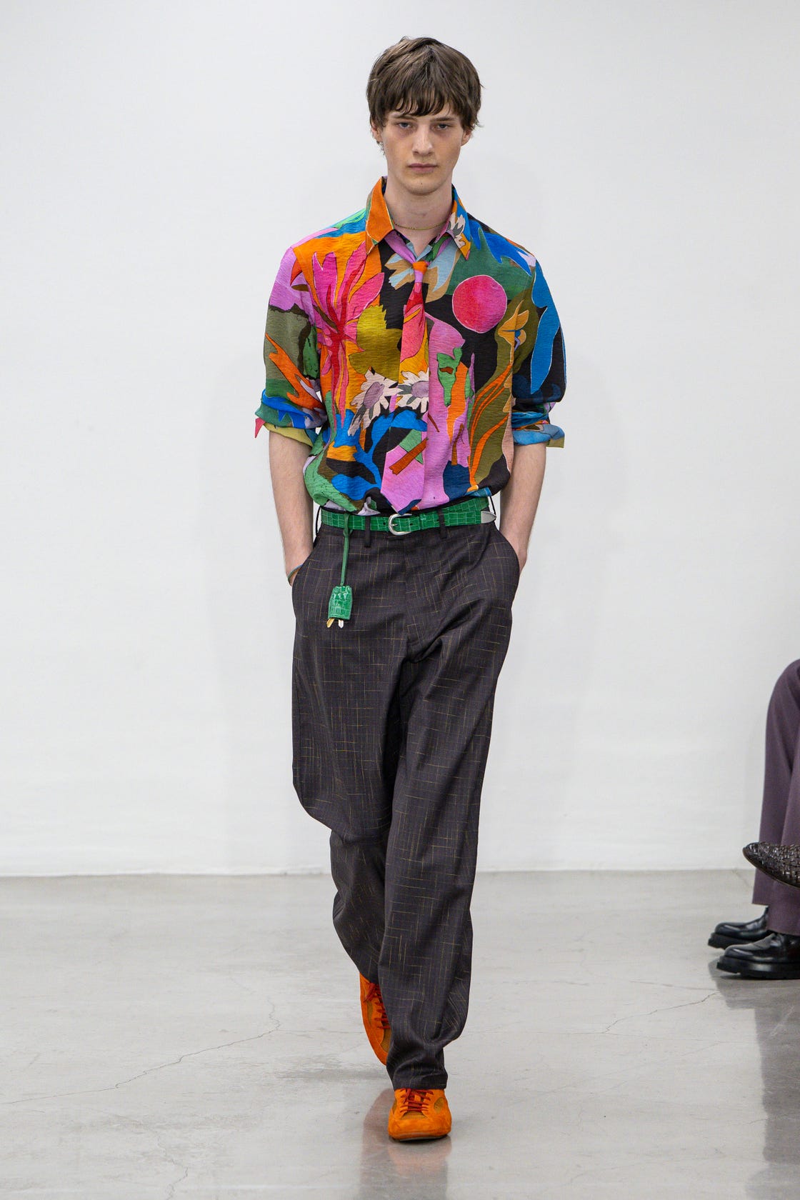 fashion model showcasing a vibrant outfit on the runway