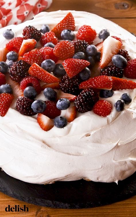 close up of a pavlova topped with berries