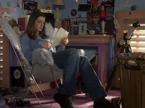 person sitting in a cozy chair reading letters