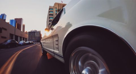 a photograph of a muscle car driving through the city as captured on a gopro hero11 black