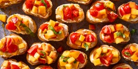 sliced toasts topped peach and tomato slices