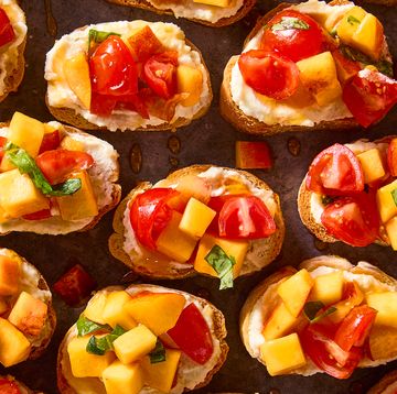 sliced toasts topped peach and tomato slices