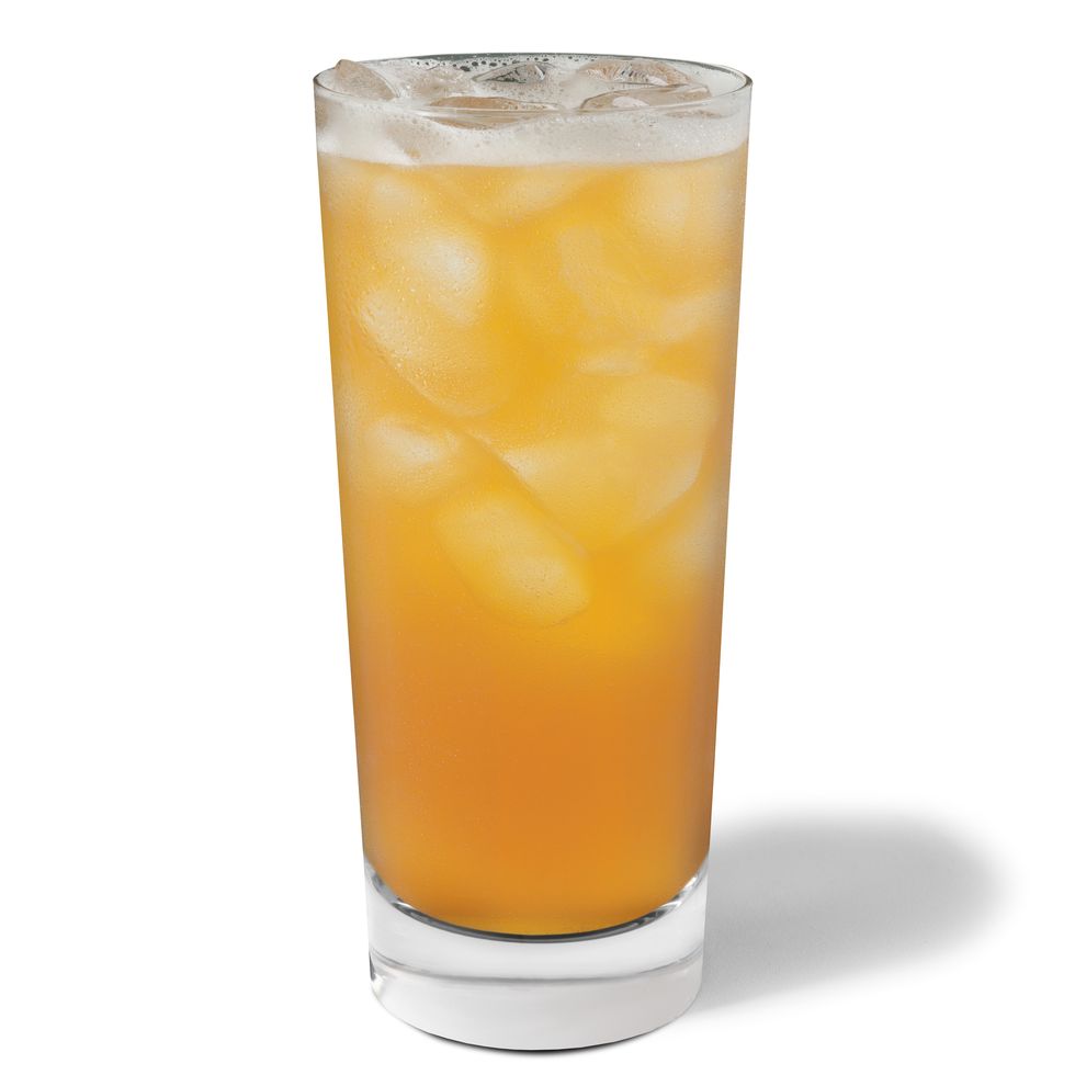 shot of starbucks peach iced tea, in a glass with ice