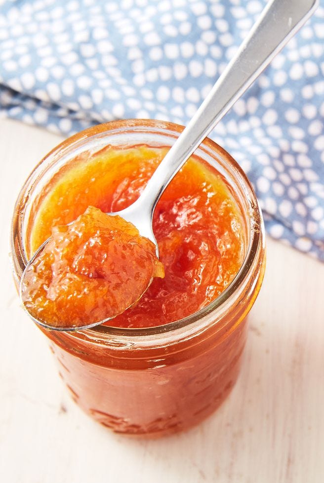 ginger peach jam in a mason jar with a spoon