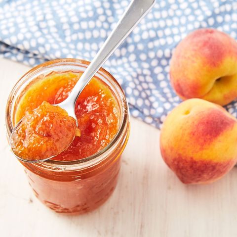 ginger peach jam in a mason jar with a spoon