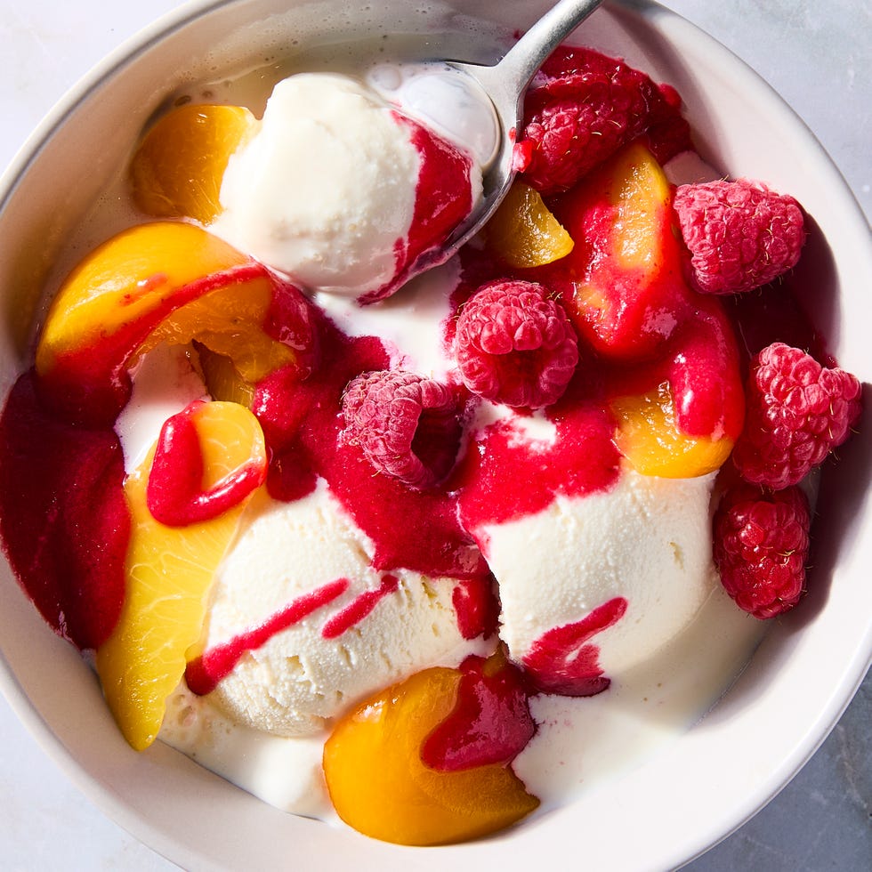 vanilla ice cream topped with peaches and raspberries