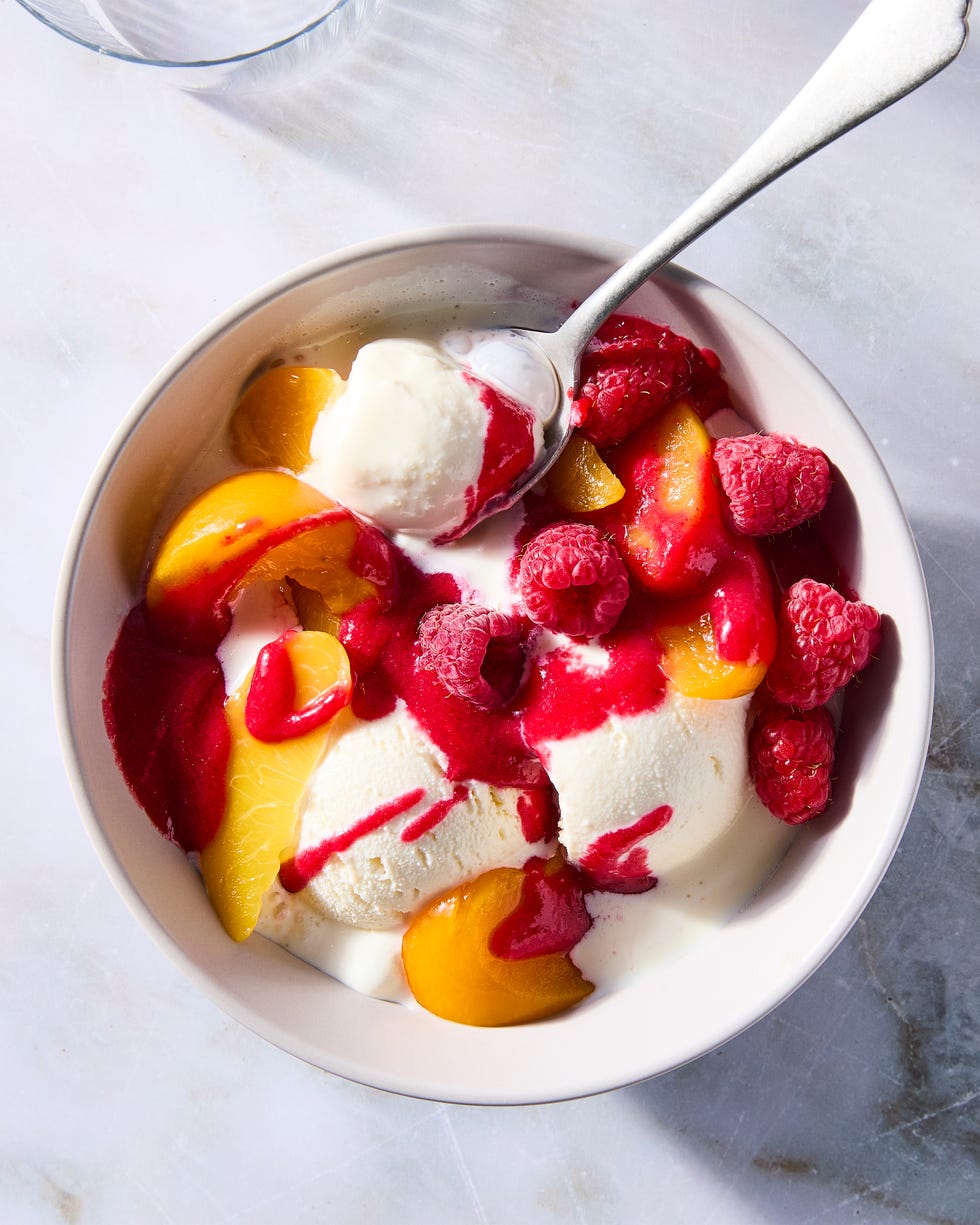 vanilla ice cream topped with peaches and raspberries