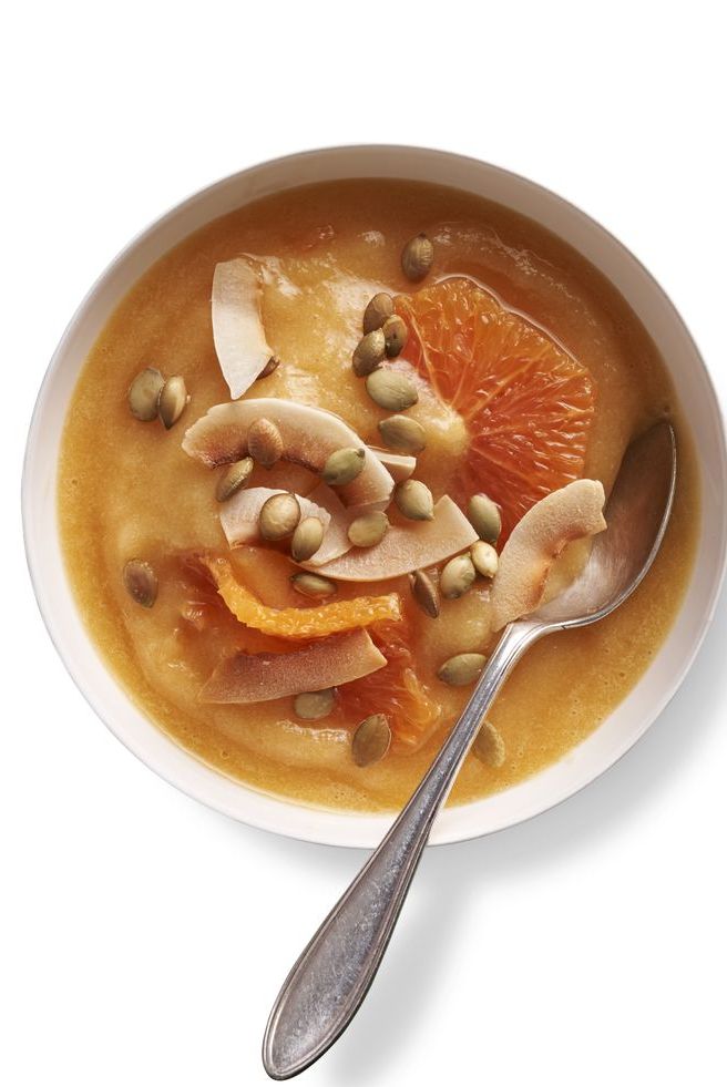 peach smoothie bowl with pepita seeds, coconut shavings, and cara cara oranges