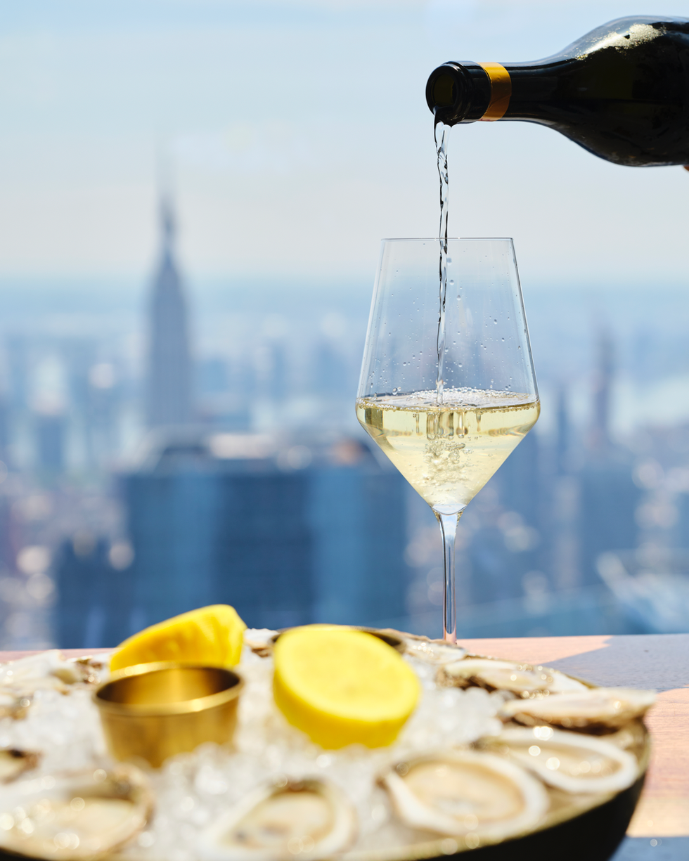 a glass of wine and lemon slices