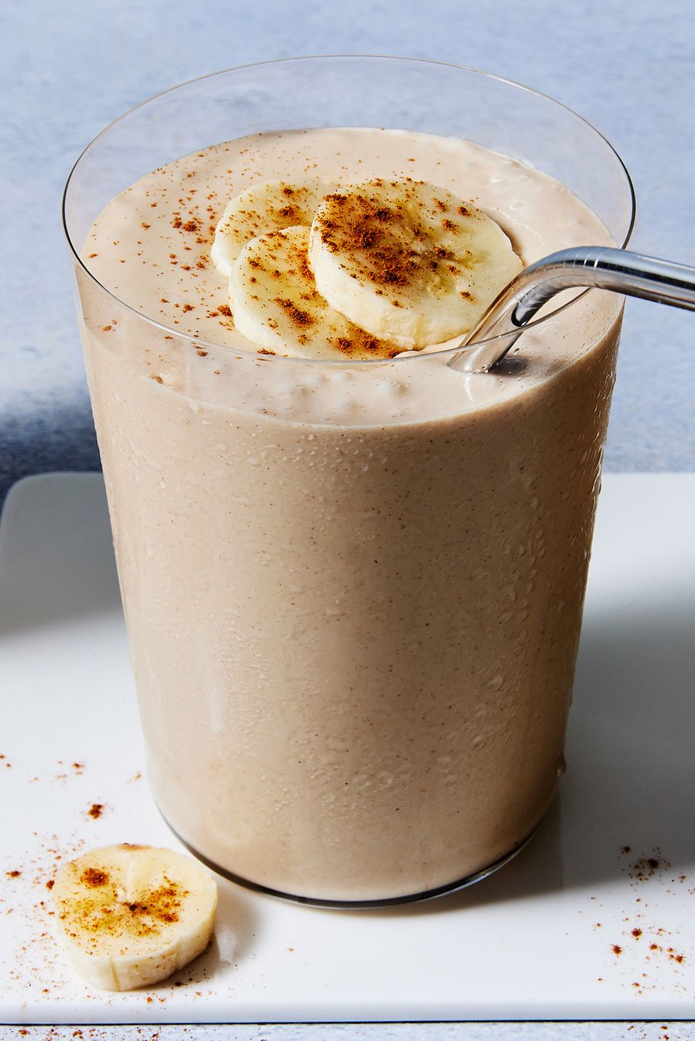 peanut butter banana smoothie with banana slices and cinnamon on top