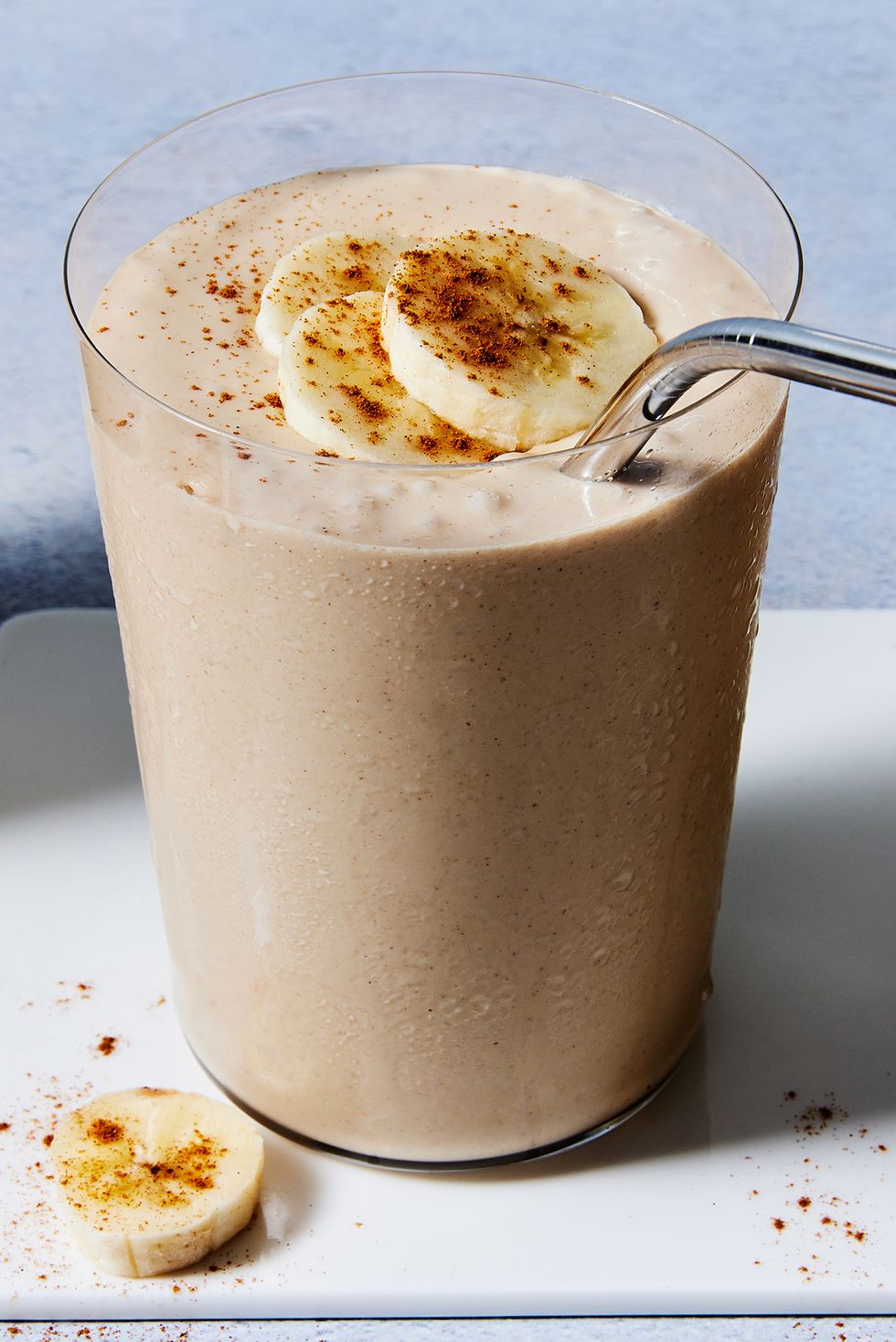 peanut butter banana smoothie with banana slices and cinnamon on top