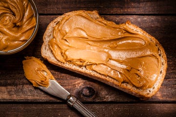 peanut butter on bread slice shot on rustic wooden table