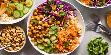 peanut chickpea protein bowls with rice, crispy chickpeas, red cabbage, carrot, cucumbers, and peanut sauce