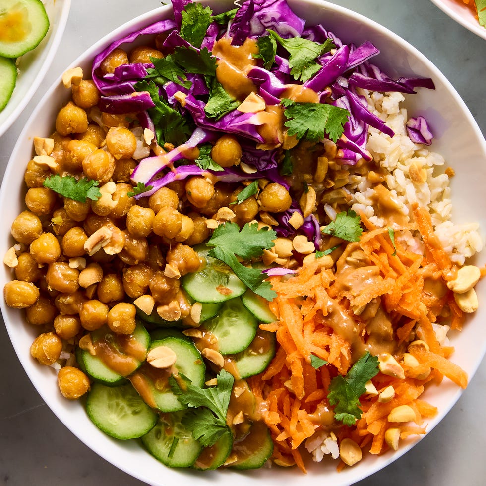 Peanut Chickpea Protein bowls peanut chickpea protein bowls with rice, crispy chickpeas, red cabbage, carrot, cucumbers, and peanut sauce