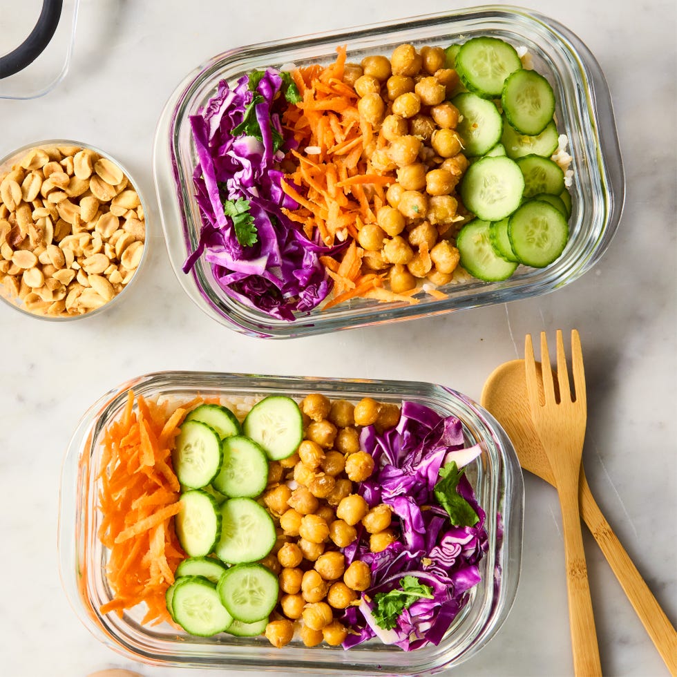 peanut chickpea protein bowls with rice, crispy chickpeas, red cabbage, carrot, cucumbers, and peanut sauce
