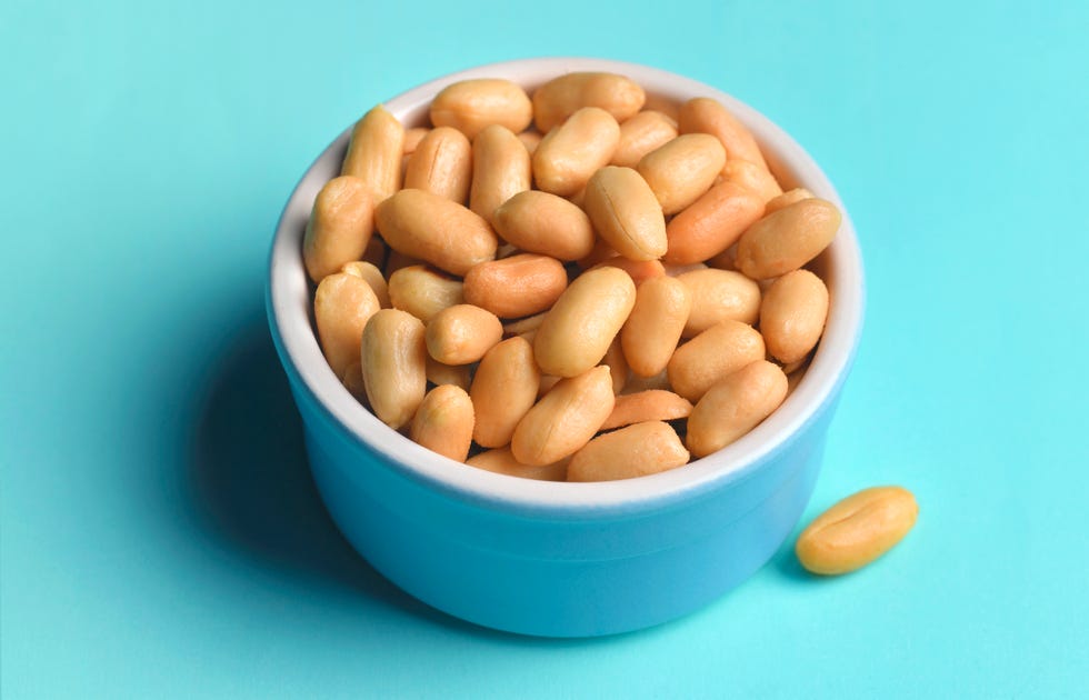 peanuts in a blue bowl on blue background