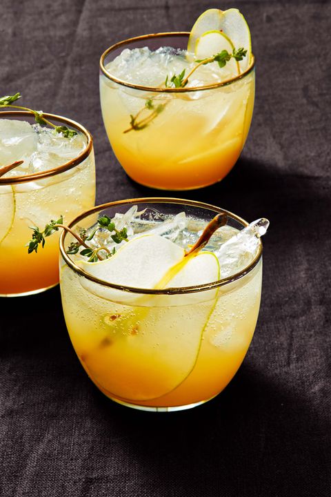 pear gin fizz in a glass with fresh thyme as a garnish