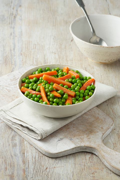 peas and carrots in white bowl on cream cotton cloth