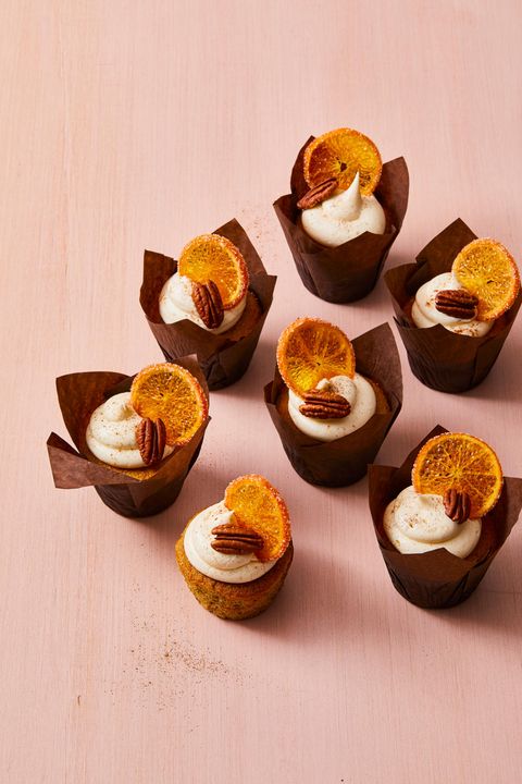 cupcakes with spiced vanilla frosting, pecans, and dried orange slices on top