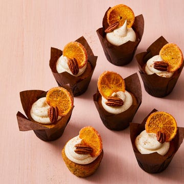 pecan cupcakes with vanilla frosting and dried orange slices on top