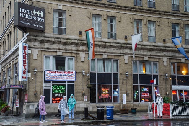 https://hips.hearstapps.com/hmg-prod/images/pedestrian-walks-past-one-of-the-neon-signs-at-ollies-news-photo-1702406596.jpg?crop=0.66699xw:1xh;center,top&resize=640:*