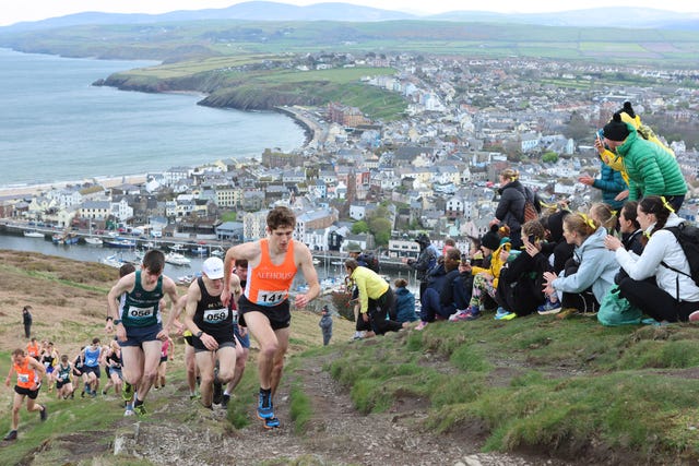 19/04/2025: mens race winner, arlo ludewick leads the group in the isle of man easter festival of running peel hill race. picture by dave kneen photography.