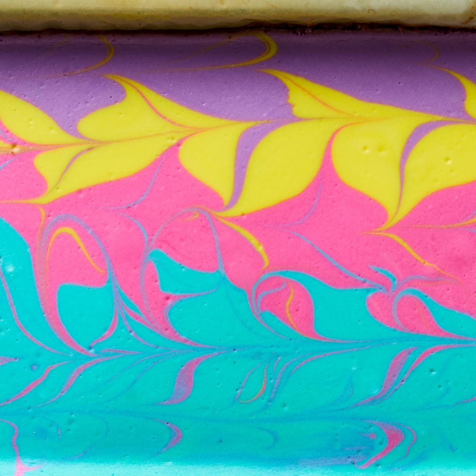 cheesecake bars swirled with yellow, purple, pink, and teal peeps colors