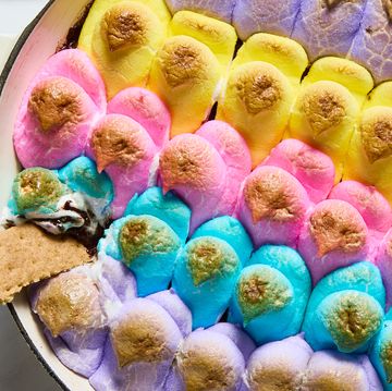 baked chocolate topped with multicolored peeps in a skillet served with graham crackers