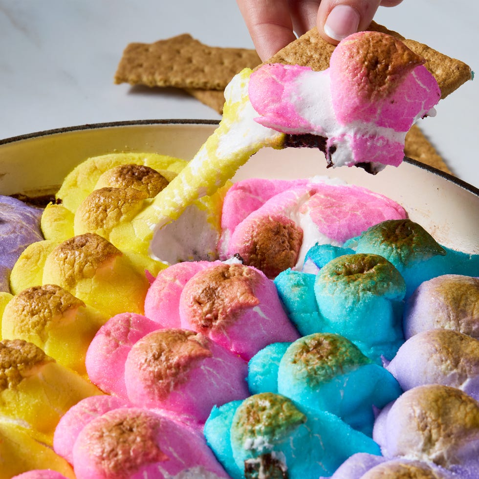 baked chocolate topped with multicolored peeps in a skillet served with graham crackers