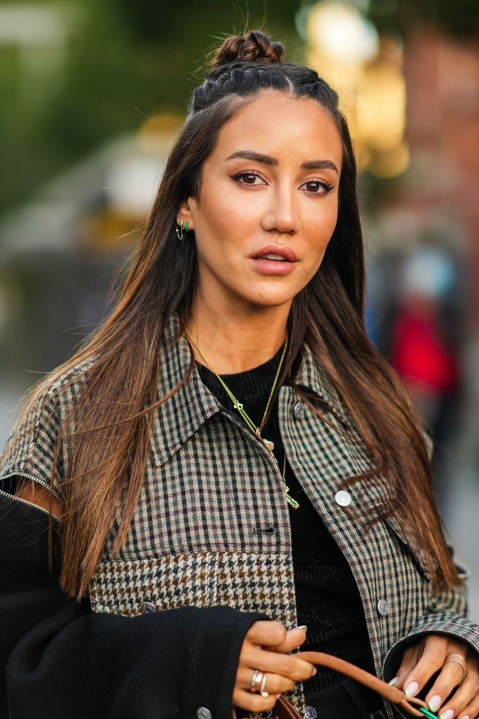 paris, france   september 29 tamara kalinic wears gold chain pendant necklaces, a brown  beige  black checkered pattern buttoned jacket with a black zipper sleeve and a matching pattern zipper sleeve, a matching brown  beige  black checkered pattern short skirt, a brown faded suede handbag from acne studio, rings, outside acne studios , during paris fashion week   womenswear spring summer 2022, on september 29, 2021 in paris, france photo by edward berthelotgetty images